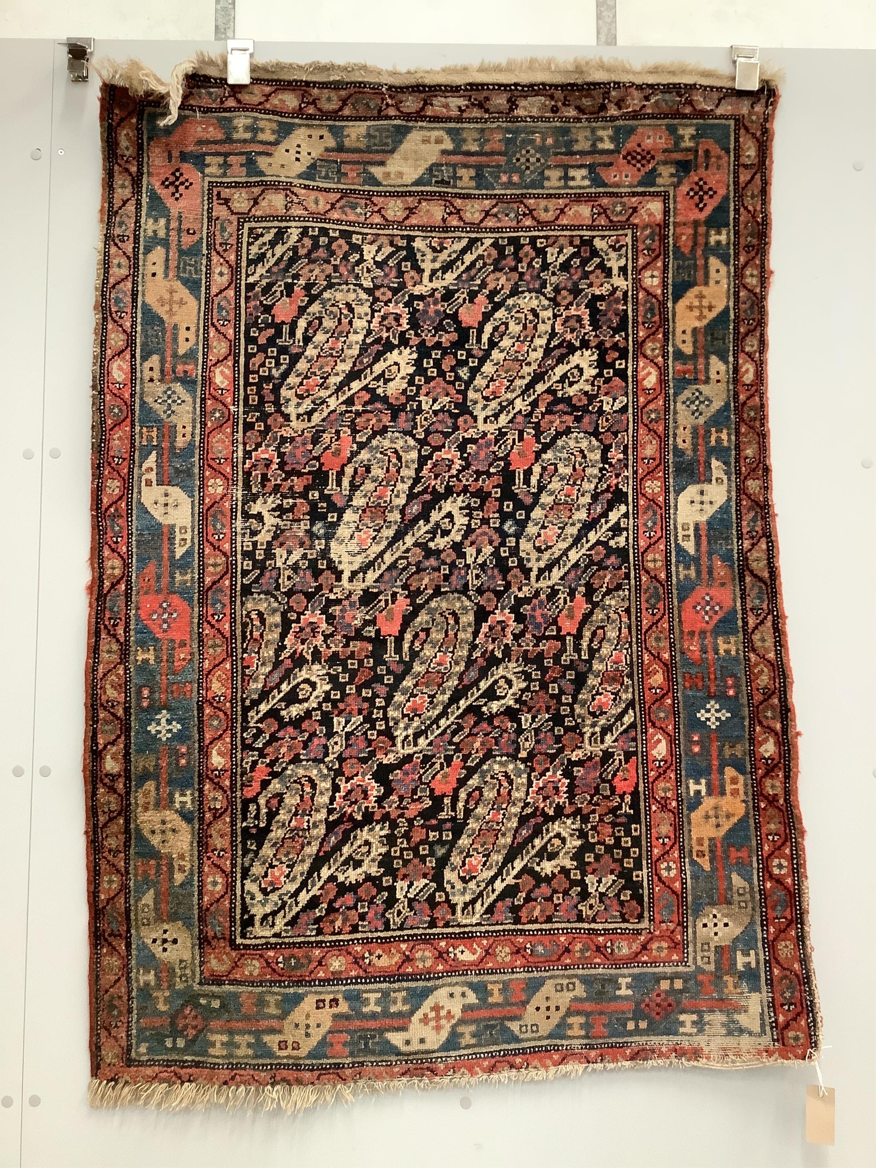 A Persian black ground rug, 140 x 97cm. Condition - faded and worn